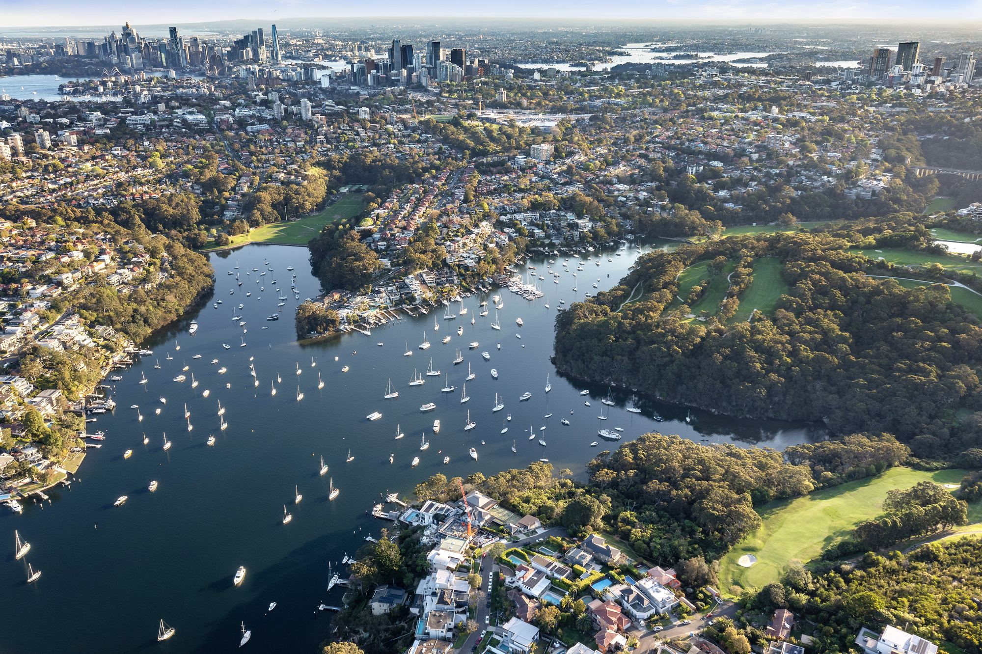 Lower North Shore harbour and the Sydney skyline from above